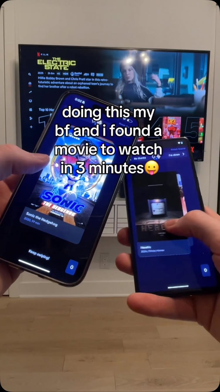 The image shows a person holding up two smartphones.  The phone on the left displays the movie poster for 'Sonic the Hedgehog' and the phone on the right shows settings or a player within an app. A television in the background displays a movie poster.