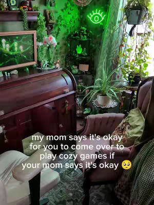 A cozy, maximalist room with a rolltop desk, a framed picture, and various decorations. The dominant colors are green and brown. Text overlaid on the image prompts the viewer to ask their mom to call to set up a playdate.