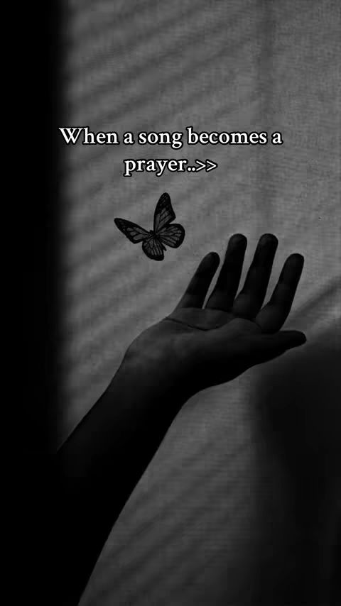 A grayscale image shows a hand reaching upwards towards a butterfly. The hand is silhouetted against a textured background, possibly a window covering. Above the hand, a butterfly appears to be flying. Text overlays the image.