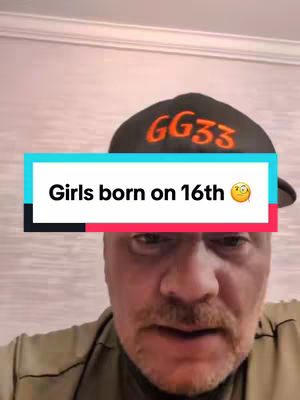 A man with a mustache wearing a black cap with orange text is looking at the camera. A text overlay in a rectangular box, with a teal-colored upper and red-colored lower part, reads 'Girls born on 16th' with a surprised face emoji.