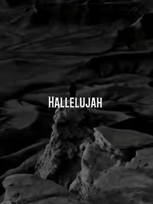 A grayscale image shows a silhouetted figure standing atop a rock formation, set against a blurred background. The text 'HALLELUJAH' is prominently displayed in a bold, white font across the center of the image.