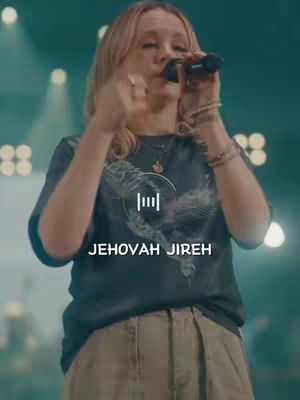 A medium shot shows a woman singing into a microphone with a blurred background of stage lights. Text overlays the image.