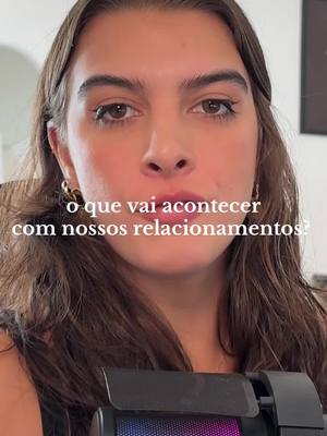 A woman with brown hair and fair skin is centered in a selfie-style shot, looking directly at the camera. Text in white is overlaid across the image. A black microphone is visible in the lower part of the image, creating a sense of a recorded or live broadcast.