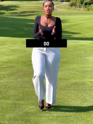 A woman stands on a green grassy area, her hands are up and open. The background has green grass and trees with a bright sunny day. A black bar has the word 'DO' on it in white text.