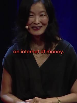 A woman with dark hair in a dark top is speaking in front of a red background. Text overlayed in red says 'an internet of money.'