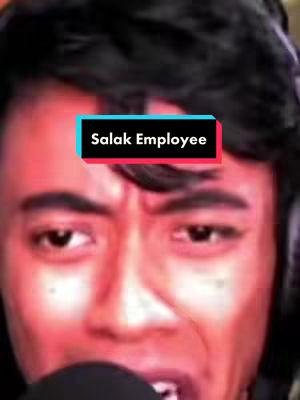 A close-up shot of a man making a surprised or exaggerated facial expression. He has black hair and is wearing a headset. A text overlay in a colored box reads "Salak Employee". The colors are dominated by reds and oranges, likely from the lighting.