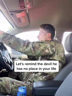 A man in a military uniform is driving a car. The cover image is taken from a low angle inside the car, showing the driver and the interior.