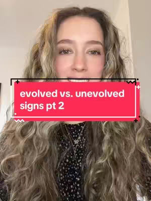 A woman with long, wavy blonde hair is centered in the frame. A red rectangle with white text reading "evolved vs. unevolved signs pt 2" overlays her chest. The background appears to be a light, neutral color.