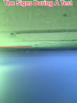 The image has a layered composition with text at the top and two distinct color zones. The top section appears to be a gradient of green and an unsaturated red, and the bottom is a solid blue. The horizon is delineated by a thin line with tiny lights.