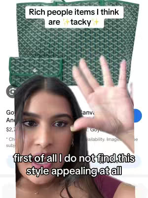 A woman is holding up her hand in front of her, with a green-colored tote bag in the background with a wallet. Text overlays on the top of the image which reads 'Rich people items I think are tacky' and another on the bottom of the image which reads: 'first of all I do not find this style appealing at all'. The creator appears to have dark hair.