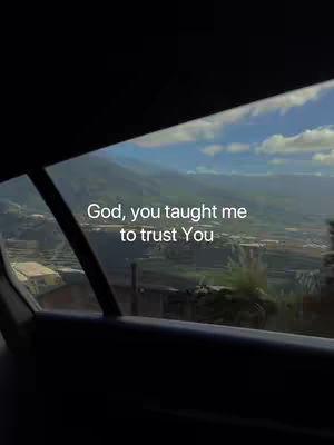 The cover image shows a view outside of a car window. The foreground is the dark interior of the car, with the edge of the window frame visible. The background is a scenic view of a lush green landscape with mountains, clear blue sky with some clouds. The words, God, you taught me to trust You, are superimposed.