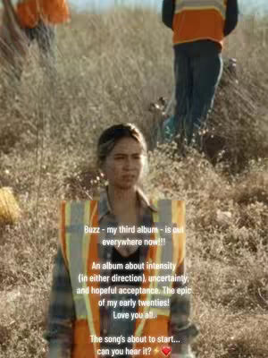 A woman in a hi-vis vest and plaid shirt stands in a field, text overlays on the image. Two people are blurred in the background.