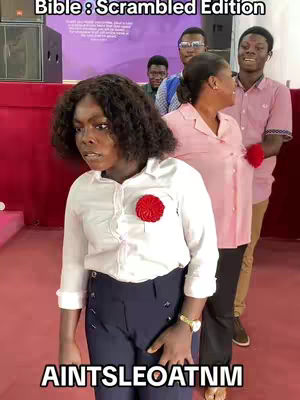 A group of people, predominantly black, are gathered in what appears to be a religious setting. The central figure is a black woman in a white blouse and dark blue pants. Her expression is one of surprise or thought. Other individuals, both men and women, stand behind her, some looking towards the camera. The background is blurred, suggesting an indoor space with a red wall and a podium or stage. Text overlays are positioned at the top and bottom.