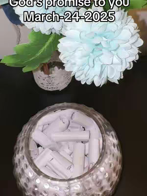 The cover image displays a glass jar filled with rolled-up white papers, possibly containing messages or promises. It is set against a dark background, and floral decorations are visible above the jar. The text overlayed on the image says, "God's promise to you March-24-2025".