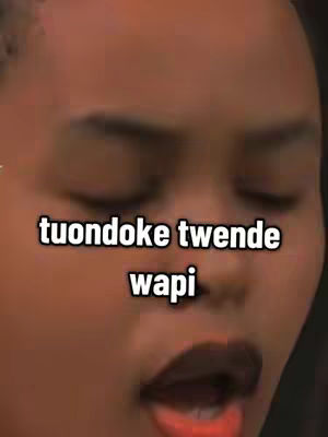 A close-up shot of a person's face with the eyes closed and mouth slightly open, with the background blurred. The person's skin appears to be a medium tone. A text overlay in a bubble font, with black, is on the upper part of the image.
