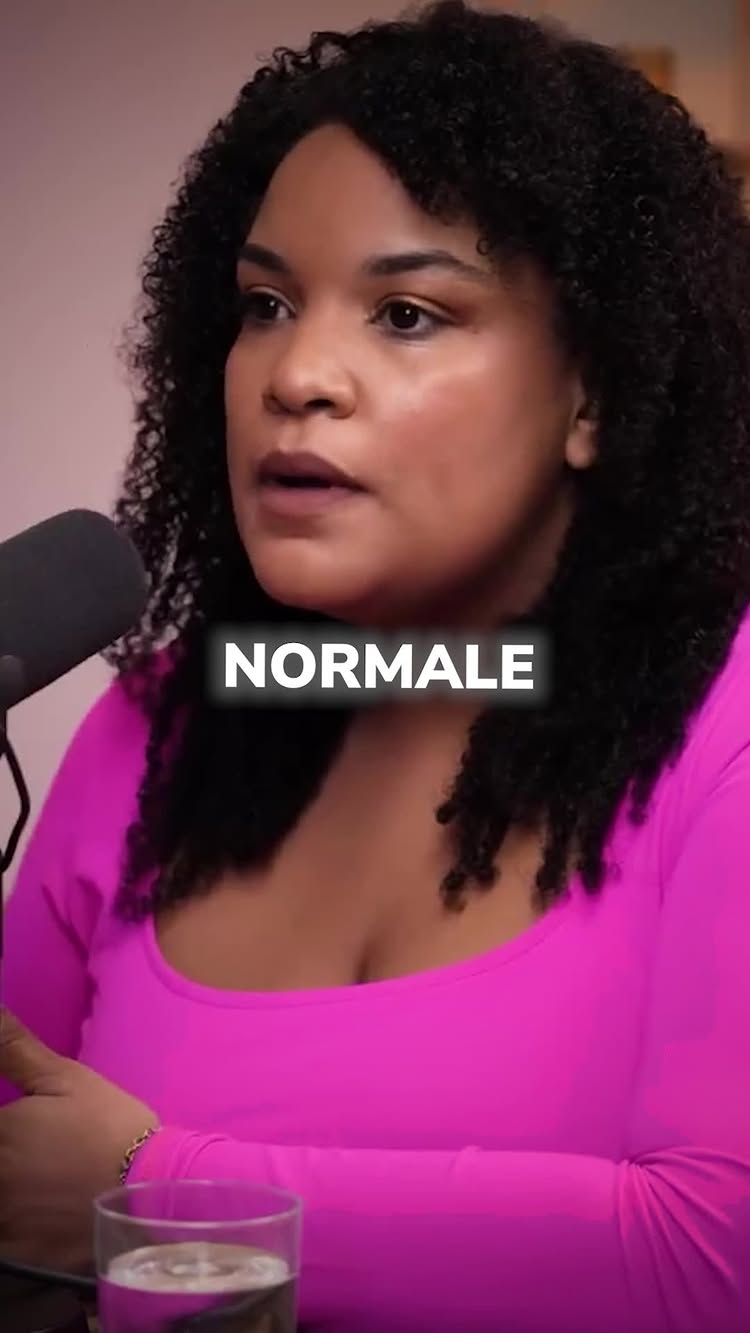 The cover image shows a close-up of a woman with curly dark hair, wearing a bright pink top. The woman is looking towards the left in the image, speaking. The word "NORMALE" appears in a white, outlined font, overlaid on her chest.