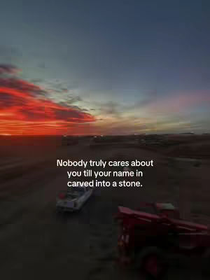 A wide shot captures a dramatic sunset over a deserted road with a car and a truck, and text overlayed over the image.