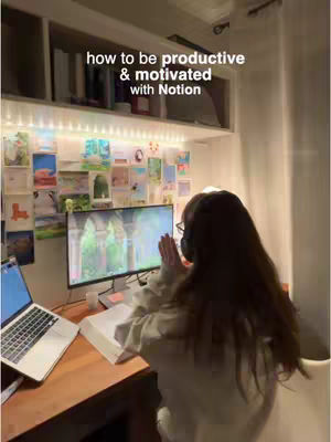 A person, presumably the creator, is seated at a desk with a laptop and a monitor, appearing to work or study. The scene is indoors, with books, notes, and decorations visible on shelves and walls, lit by fairy lights.