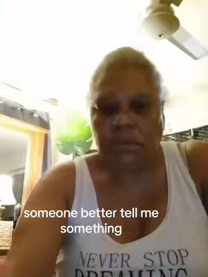 The cover image shows a selfie-style video where a woman in a white tank top with the words "NEVER STOP DREAMING" is the primary focus. She has a somewhat serious expression. The background is blurry, but suggests an indoor setting with a window and ceiling fan visible.