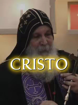 The cover image features a man wearing a black hooded garment and a white beard. The word "CRISTO" in large, glowing yellow letters is overlaid on the image. He appears to be holding religious items, suggesting a religious context.