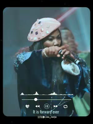 The cover photo features a woman wearing a decorated pink hat, singing into a microphone. The image has a film-style effect with music controls overlayed at the bottom and text "It is forward ever". The background is blurred with a stage setting visible behind the singer.