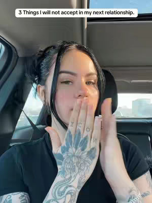 A woman in a car is shown, with her mouth covered by her hand. She has tattoos on her hand that partially spell out the word "ICON". A text overlay at the top reads, "3 Things I will not accept in my next relationship."