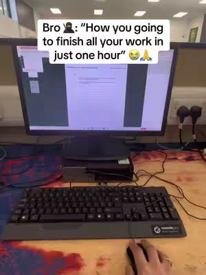 A desk setup with a desktop computer, keyboard, and mouse is shown. On the screen, there is an overlay saying, 'How you going to finish all your work in just one hour?'