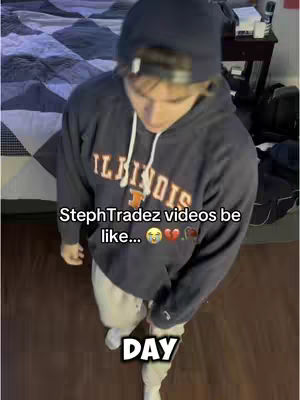 A young man wearing a black hoodie and a beanie is captured from a slightly elevated angle. Text overlays are added. The man is looking down at the camera with the word DAY in a box.