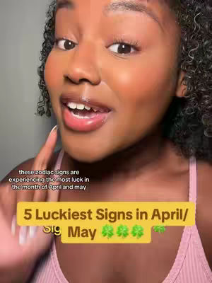 A close-up shot of a woman, smiling and gesturing with her finger, with overlayed text about astrology and luck. The background is slightly blurred, focusing on the woman's face and the overlaid text. The color palette is warm, with the woman having a tan complexion and wearing a pink top.