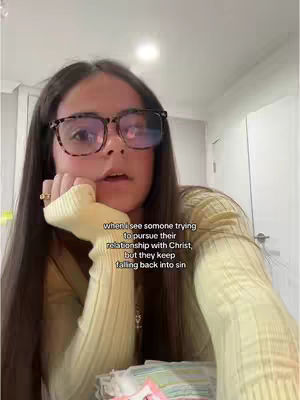 The cover image shows a well-lit, indoor scene with a young woman centered. She's wearing glasses and a yellow sweater. Her hands are clasped, with one hand supporting her chin. Text in a white rectangular box is overlaid on the image, describing a relatable feeling. The background is softly blurred, focusing attention on the woman. 