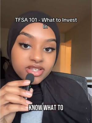A woman with dark hair and a hijab is centered in the frame, holding a microphone. Text overlays read, "TFSA 101 - What to Invest In" and "KNOW WHAT TO". The background is blurred, suggesting an indoor setting.