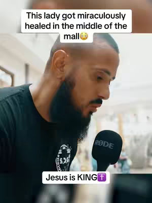 A man with a beard is holding a microphone, with overlaid text about divine healing.