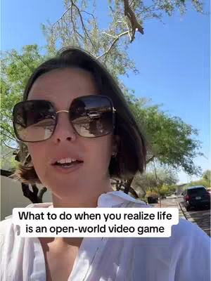 A woman wearing large sunglasses stands outside in front of trees and a blue sky. The composition focuses on the woman's face with a text overlay. A road with cars and houses is visible in the background.