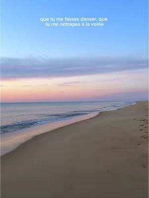 A scenic shot of a beach at dusk or dawn. The sky transitions from blue at the top to pink and orange near the horizon, reflecting in the calm water. The beach is sandy and stretches into the distance, with gentle waves lapping at the shore. Text overlayed on the image.