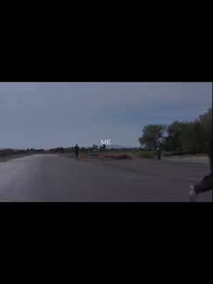 The image shows a long, empty road stretching into the distance under a cloudy sky. In the center, two figures, silhouetted, appear as if walking or running away from the camera. Above them, the word 'ME' is placed, centered on the road, in a light font.