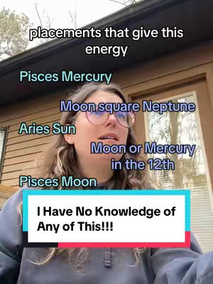 A woman with fair skin and light brown hair stares up and slightly to her right, wearing glasses and a light blue oversized hoodie. Above her head, text labels various astrological placements such as "Pisces Mercury" and "Aries Sun." A white rectangular box with the text, "I Have No Knowledge of  Any of This!!!" is positioned at the bottom of the frame. The background includes a wooden structure and greenery, suggesting an outdoor setting.