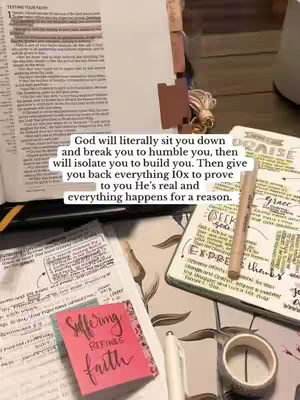 The image shows a desk with open books and notes. On display are a bible, a notebook with handwritten notes and highlighted text, and a pink sticky note with the words “Suffering Refines Faith” in calligraphy. A white pen and a roll of patterned washi tape are present, with a pencil laying on a journal.