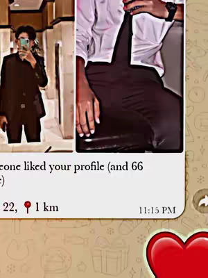 The cover image is a split-screen. On the left, a person in a dark suit is taking a selfie with a phone in front of a mirror, reflecting the person's face. On the right, the lower half of another person is visible; this person is wearing a white collared shirt and dark pants. A notification overlay is visible in the bottom half of the cover image, showing a message and timestamp.