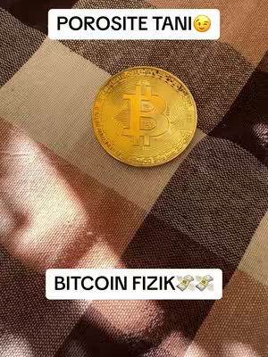 The image features a golden Bitcoin coin at the center, set against a textured background of tan and brown interwoven threads. Above the coin is a white banner with the text "POROSITE TANI" and a smiling emoji. Below the coin is another white banner with the text "BITCOIN FIZIK" followed by an emoji of money bags.