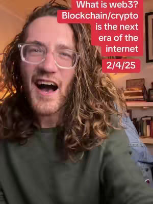 A man with long, curly brown hair and glasses is in the center of the frame. He is looking at the camera with his mouth open, mid-speech. The background is slightly blurred, with bookshelves visible. A red rectangle houses white text: "What is web3? Blockchain/crypto is the next era of the internet 2/4/25". The man is wearing a dark green sweater.