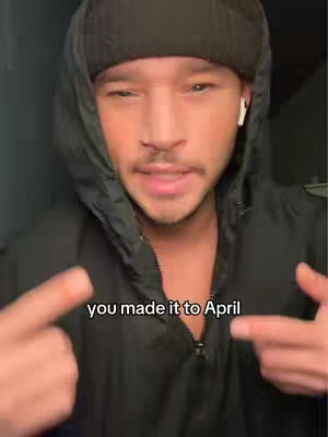 A man wearing a black beanie and black hoodie is the main focus of this selfie-style video cover image. The man has fair skin and carries a neutral facial expression. He is pointing at the hook text which is overlaid on the image