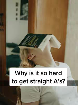 A person with blonde hair has a book balanced on their head, with their neck arched back. They are wearing a white shirt in a room with simple decor. The background includes a wooden door and a glimpse of a bed.