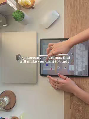 The cover image shows a top-down view of a desk setting. In the setting there is a laptop, a tablet with a white stylus, the hands of a person with long nails and rings on their fingers, a white mouse, and some decorative items such as a small succulent and a candle holder. The lighting is natural, probably from a window.