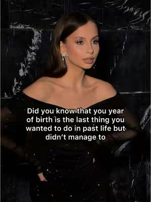 A medium shot features a woman in a black dress posing in front of a dark, marble-textured wall. The woman has light skin, dark hair, and is wearing dangling earrings. Overlayed on the image is white text.