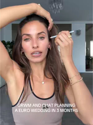 The cover image shows a woman in a light-colored tank top applying makeup while looking at the camera. Text overlayed at the bottom says "GRWM AND CHAT PLANNING A EURO WEDDING IN 3 MONTHS". The background suggests a well-lit interior space.