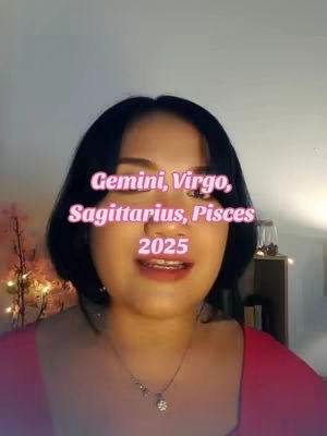 A woman with dark hair and a pink top is centered in the frame, with the text overlay "Gemini, Virgo, Sagittarius, Pisces 2025" in a pink font. The background is soft, with hints of a warm, indoor setting, suggesting a casual, conversational video.