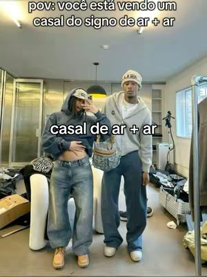 A picture of a couple standing in a room. Text overlays are present at the top and bottom. In the image, a man and a woman are visible. They are wearing casual outfits and are standing close together. The background appears to be a room with various items scattered around. The lighting is bright. Overall, the image has a casual and intimate feel.