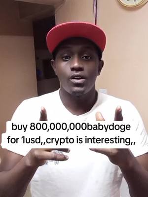 A man wearing a red baseball cap and a white t-shirt is centered in the frame, holding up his hands to display a text overlay about buying cryptocurrency. He is facing the camera directly against a blurred background.