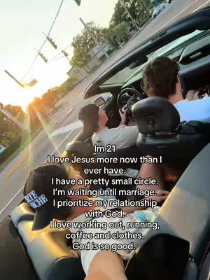 A photo taken from the inside of a convertible car. The primary subject is a young man in the driver's seat and another in the seat next to him. The image is taken from a low angle, looking towards the front of the car, with a bright sun in the upper left shining. Text is overlaid with personal details and religious beliefs.