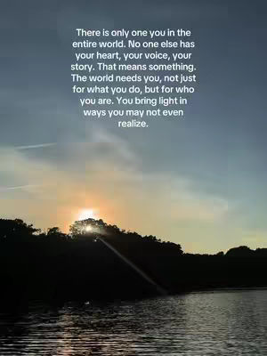 A serene landscape with a lake and silhouetted trees. The sky transitions from a gradient of blues to a warm orange and yellow, suggesting a sunset. Text is overlaid, offering an inspirational message.